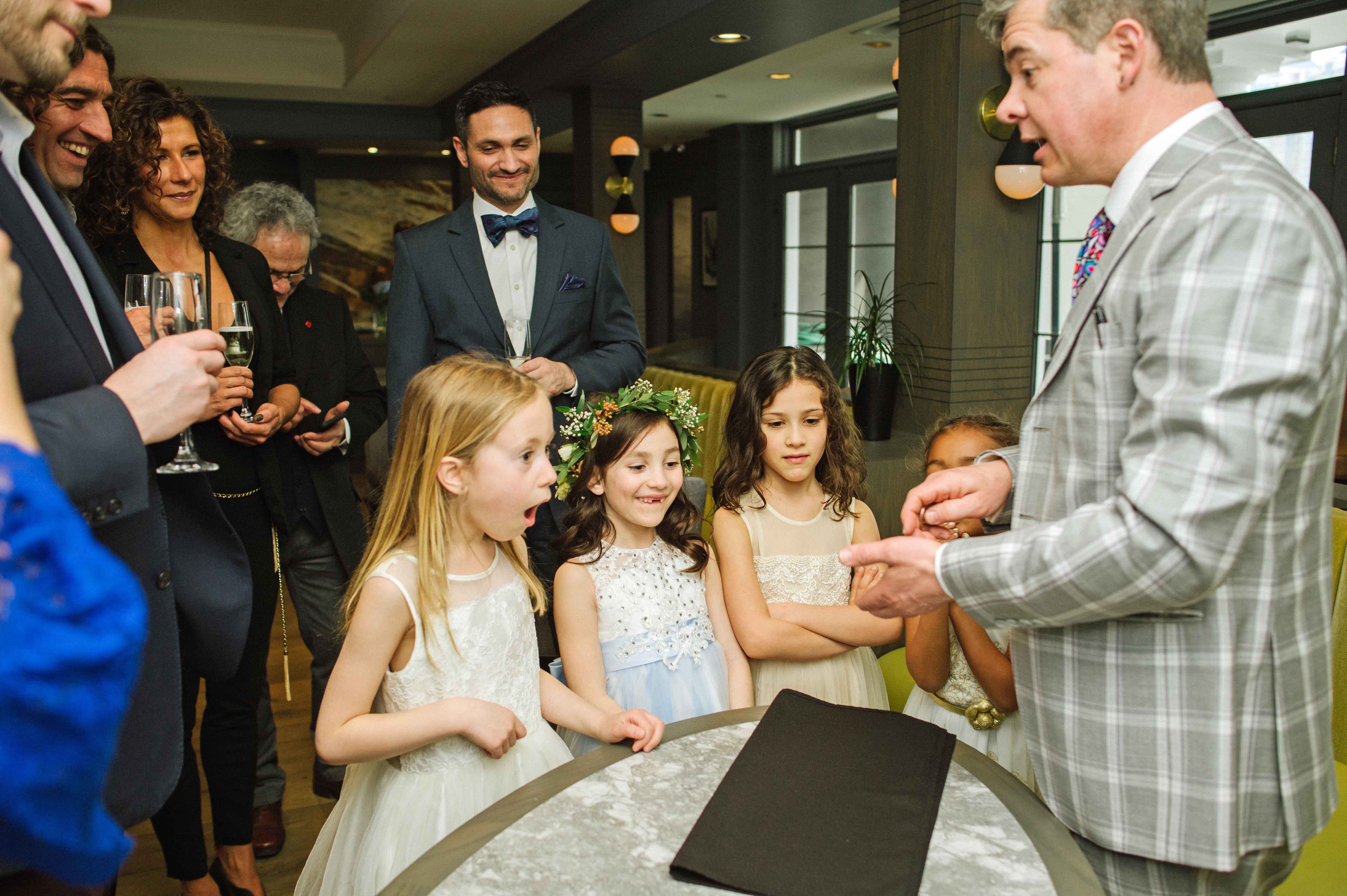 Malcolm performing card trick for flower girls